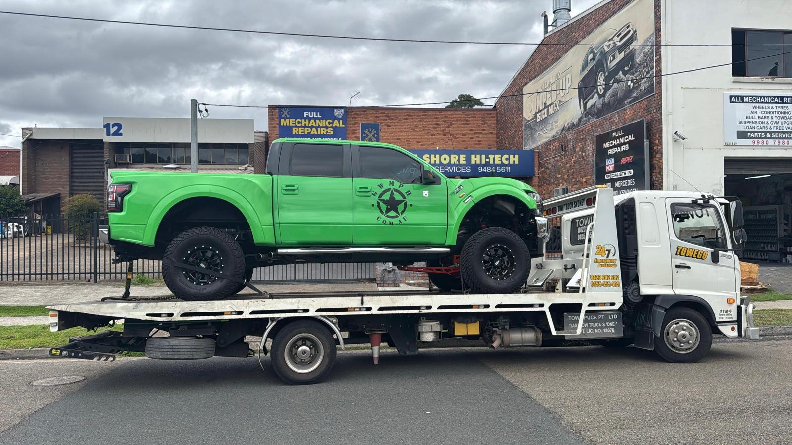 Opal Towing flatbed tow truck on a Sydney street